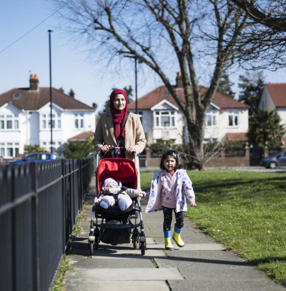 Woman and daughter walking through Hounslow on a sunny day