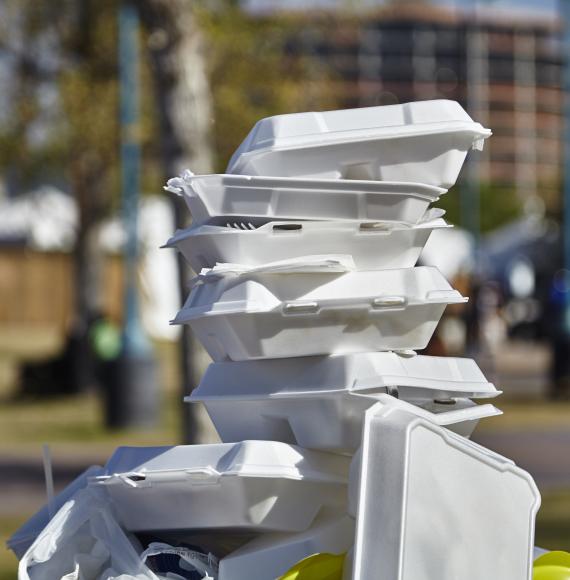 A pile of single use plastic boxes