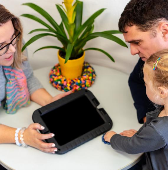 Father and toddler daughter in therapist office during counselling assessment meeting