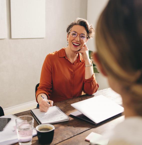 Happy businesswoman interviewing a job candidate