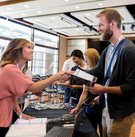 Two people meeting at a careers fair