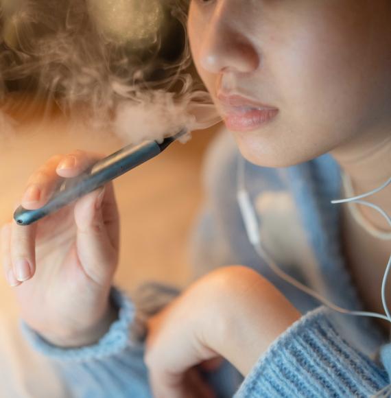 Woman smoking electronic cigarette