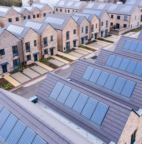 Aerial view of rows of energy efficient new build modular terraced houses in the UK