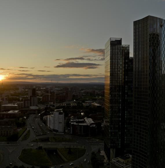 An aerial photograph of downtown Manchester at sunset