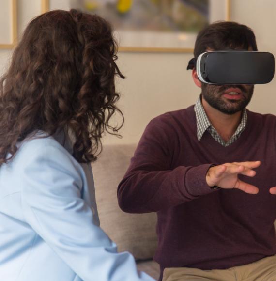 Front view of tranquil young man testing virtual reality headset