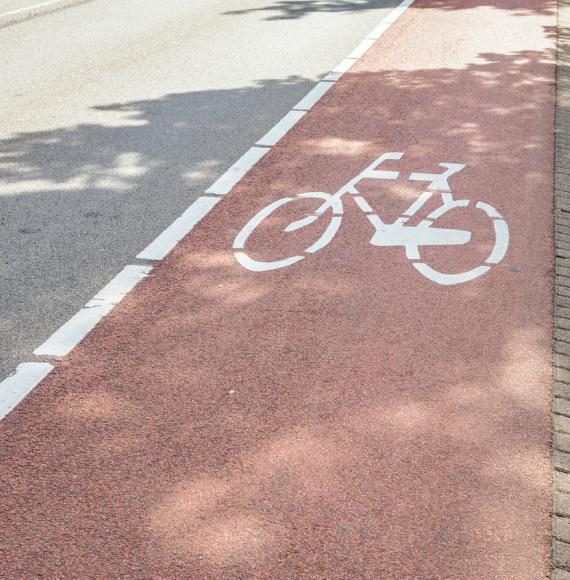 Red bicycle lane along a street in a city centre