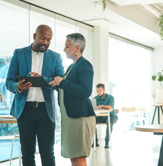 Business people talking around a tablet