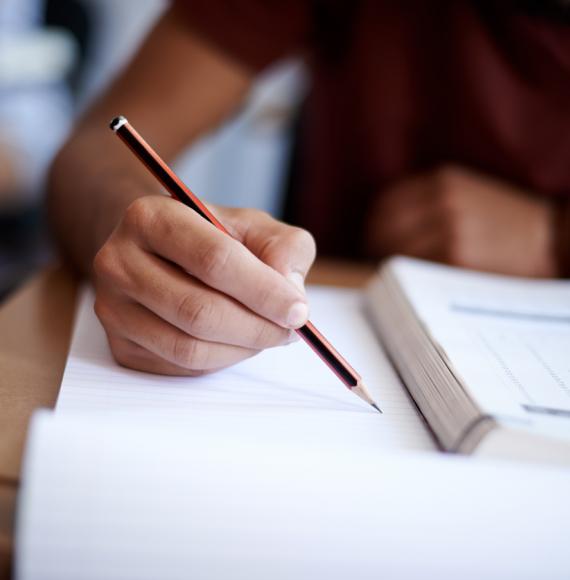 Closeup shot of an ex-offender writing on a note pad