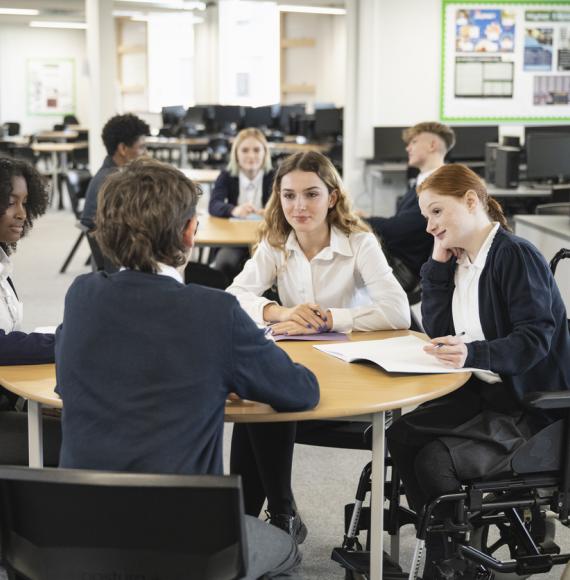 Teenage students interacting in collaborative workspace