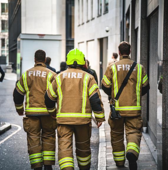 Three firefighters walking in London