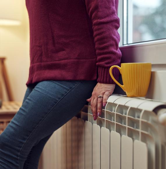 Woman heating on a chilly winter day