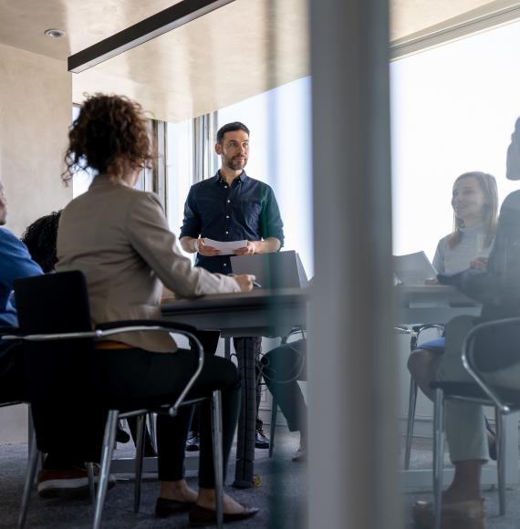 man talking to his team in a meeting at the office