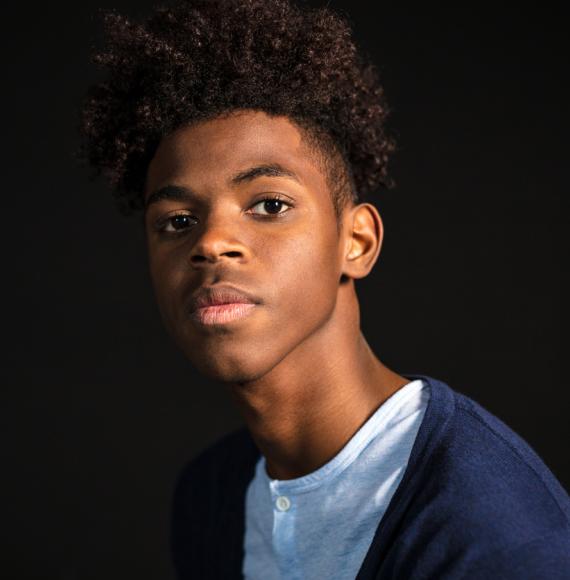 Close-up portrait of confident young man in casuals looking at camera