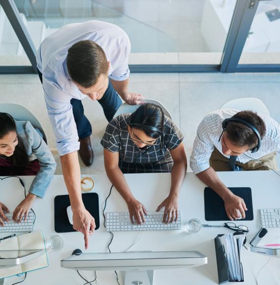 High angle shot of a man assisting apprentices