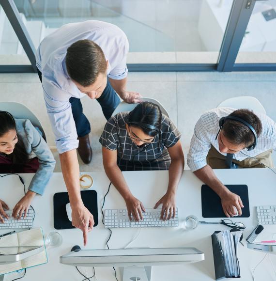 High angle shot of a man assisting apprentices