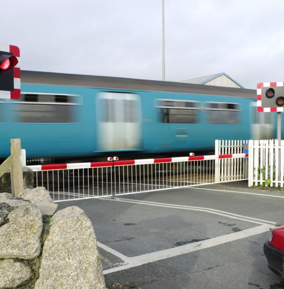 Motion Blurred Train At Level Crossing Cornwall UK