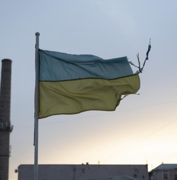 weathered Ukrainian flag flies in the Podil district of Kyiv, Ukraine