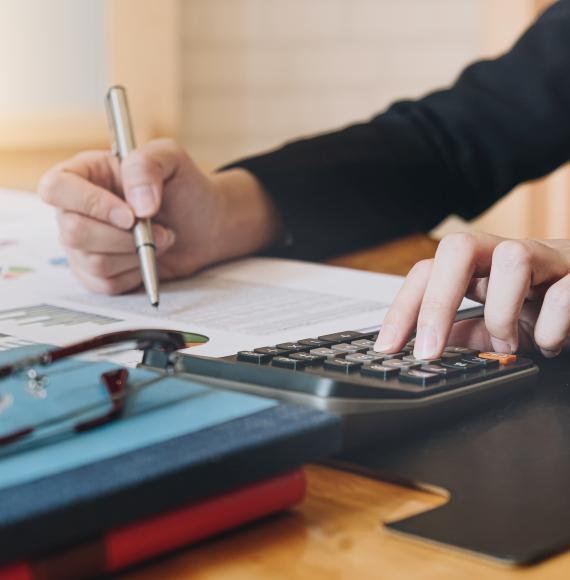 Accountant working with calculator for investigation