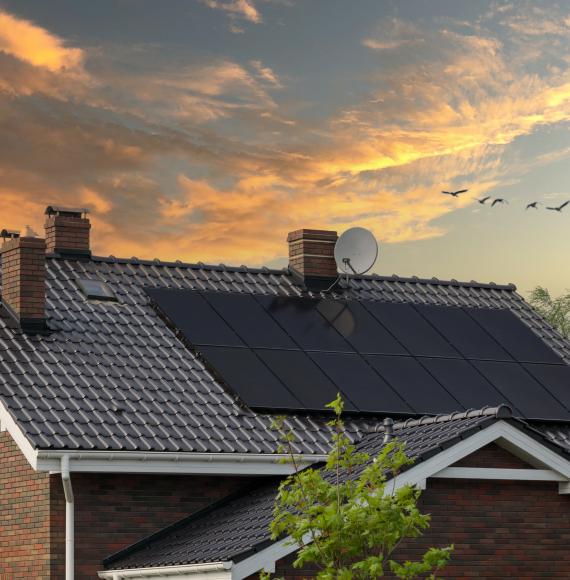 Brick house, solar panels, beautiful sunset.