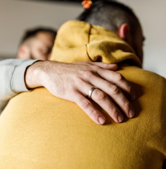 Close up shot of compassionate man embracing his friend