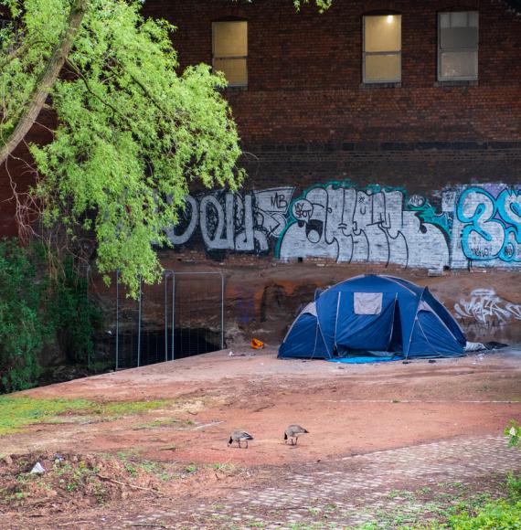a tent hosting homeless people by the canal in Castlefield, Manchester