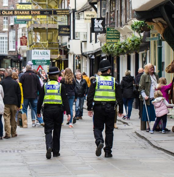 A pair of British policemen and woman on patrol on the streets of York