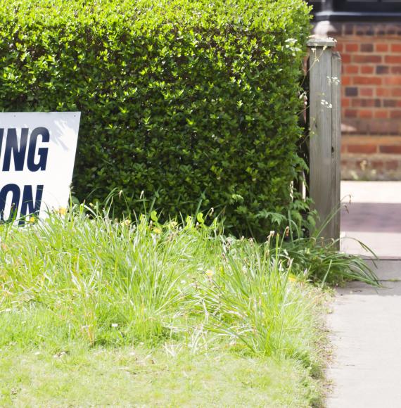 a woman taking her polling card to cast her vote