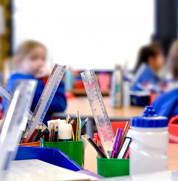 School classroom scene with kids learning in background