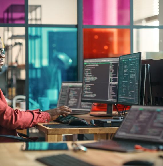 Man writing lines of code on a computer