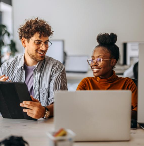 Two young colleagues working together at modern office