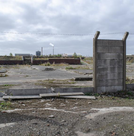 Brownfield land site with derelict wall