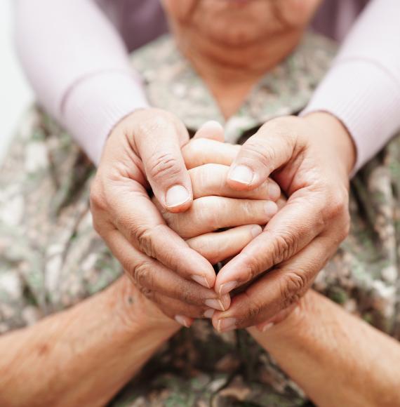 Carer holding hands with patient