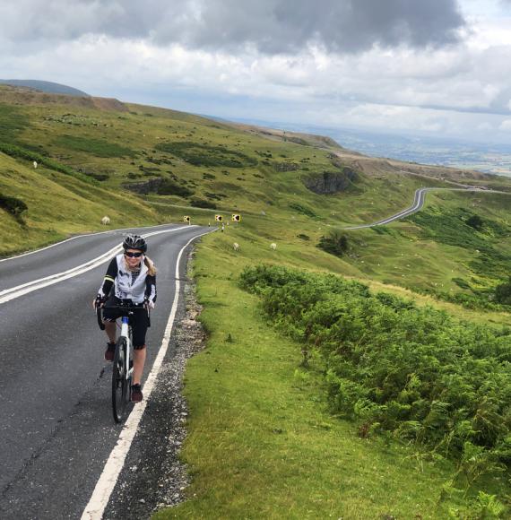 Female cyclist riding in Brecon Beacons, Wales