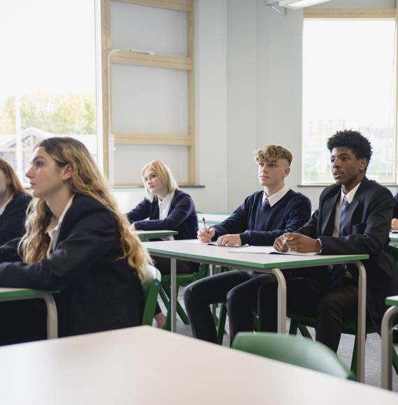 Male and female teenagers in secondary classroom
