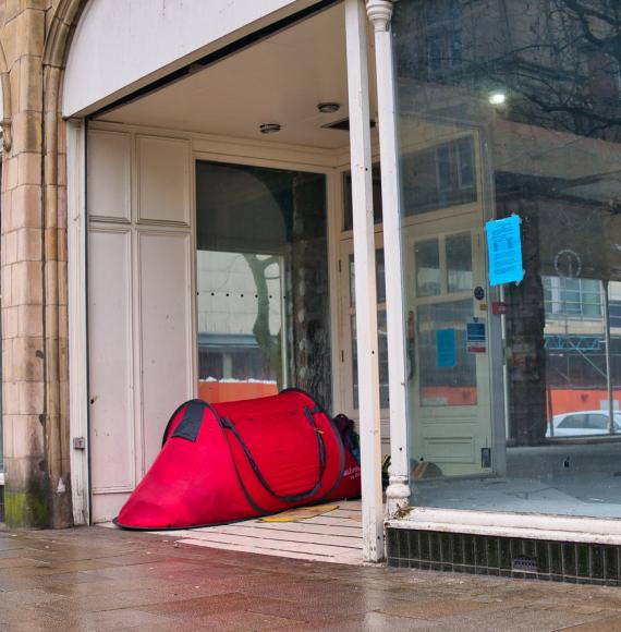 Tent in the doorway of a closed shop in the UK