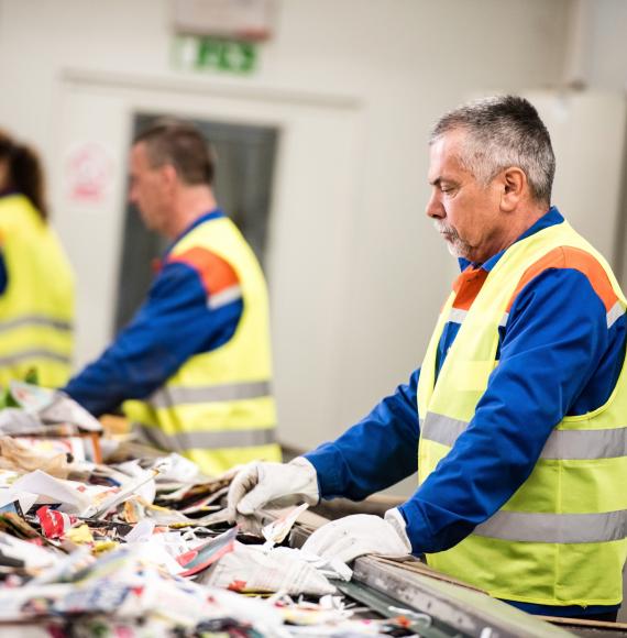 Man working at paper recycling plant