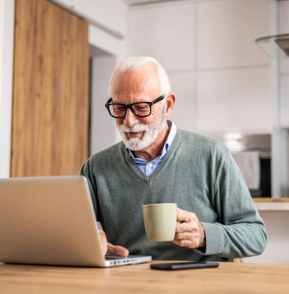 Pensioner using a laptop