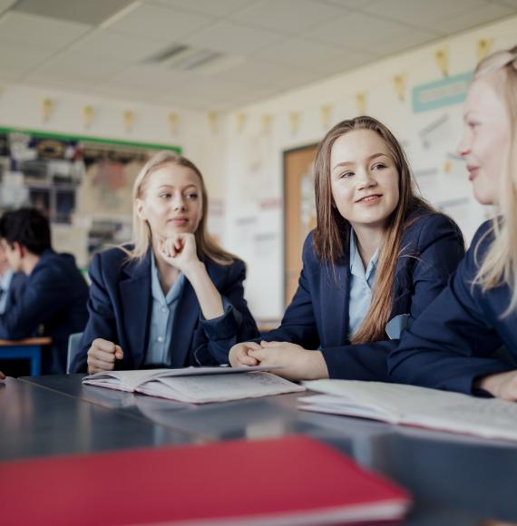 female students talking during a lesson