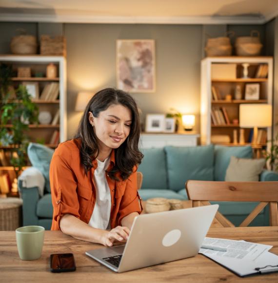 A young woman using a computer at home
