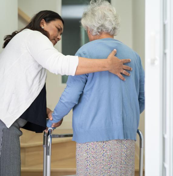 Caregiver helping an elderly woman