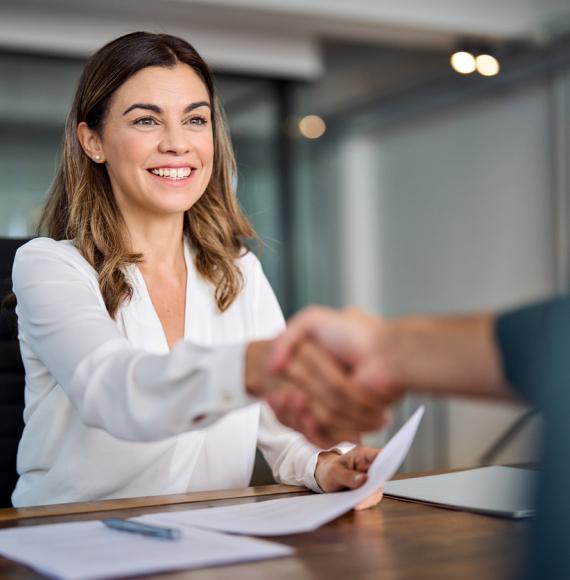Smiling businesswoman shaking hands