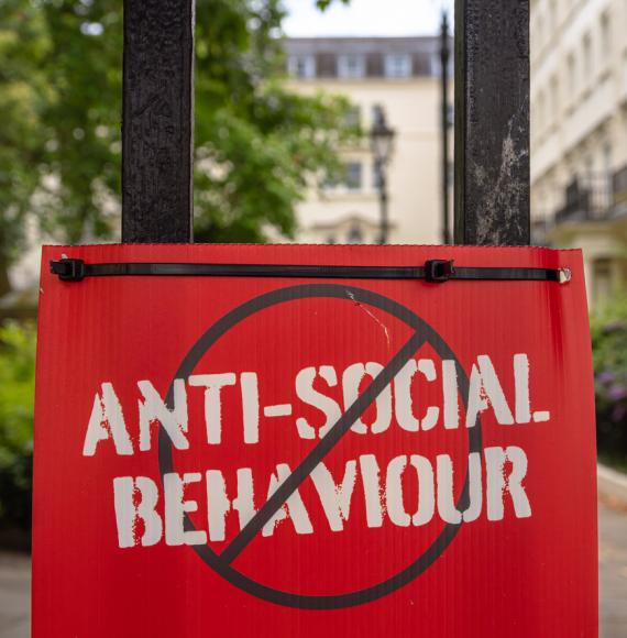 Sign with 'antisocial behaviour' crossed out
