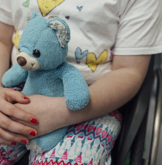 Small child holding a teddy