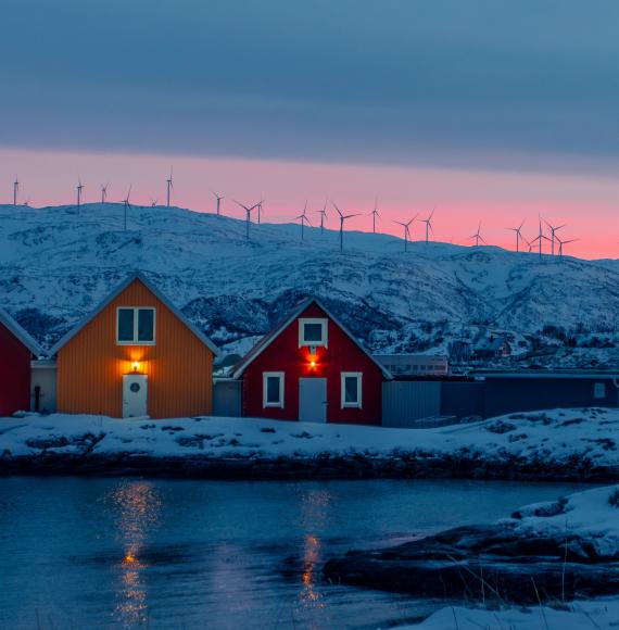 House in Norway with wind turbines behind