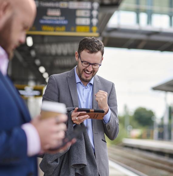 Men on phone at railway station