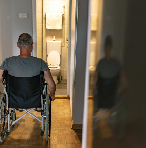 Rear view of mature man on wheelchair