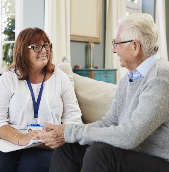 Support Worker Visits Senior Man At Home