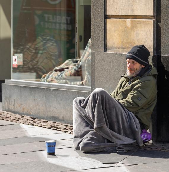 A homeless man sitting on the streets