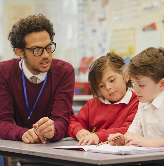 Teacher working with two students
