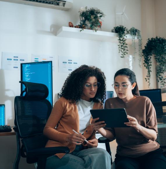 Two women working on computers